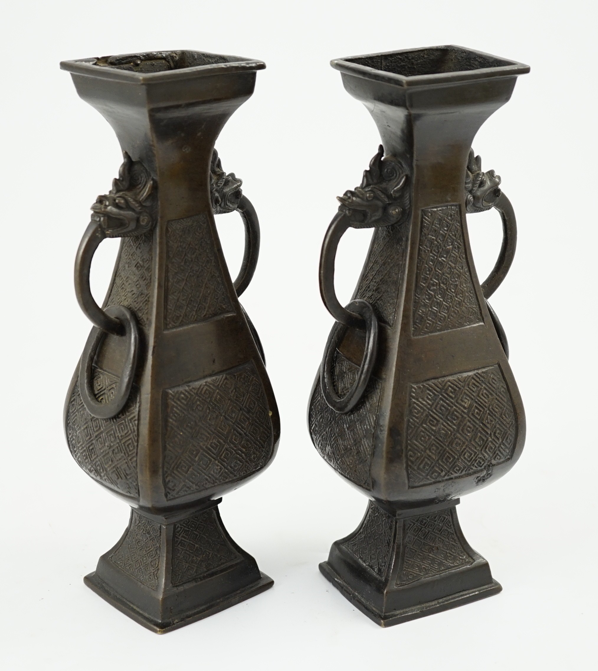 A pair of Chinese archaistic bronze two handled altar vases, Ming dynasty, 23cm high